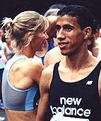 Colleen De Reuck and Khalid Khannouchi are all smiles lining up for the start of the flat, fast, New Haven 20K. - nhstart